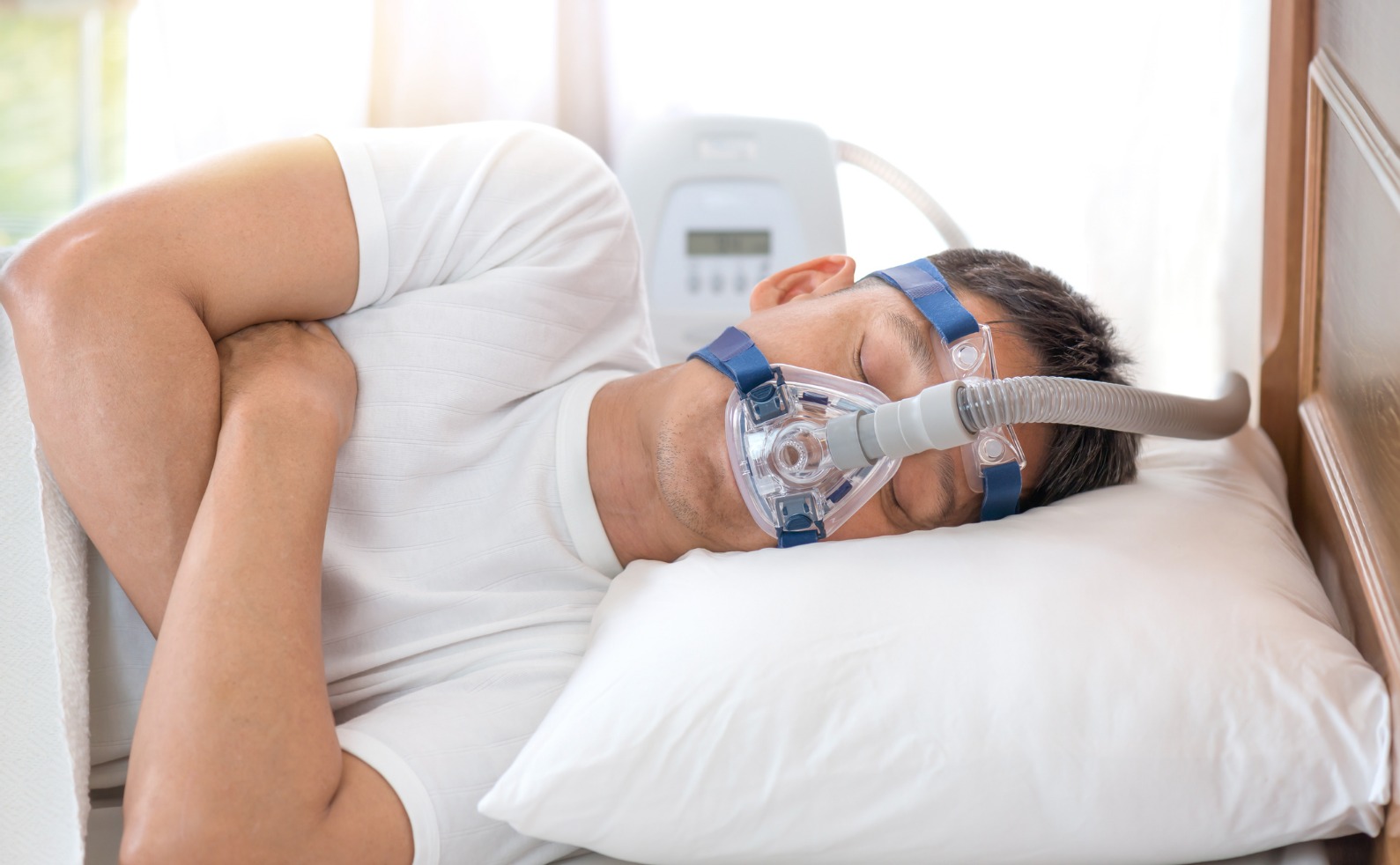 FINALman sleeping in bed wearing cpap mask sleep apnea therapy picture id629586444