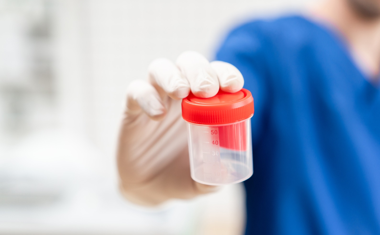 doctor in blue uniform and latex gloves is holding an empty plastic picture id1165744638