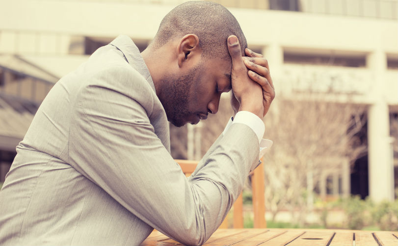stressed businessman sitting outside corporate office thumbnail