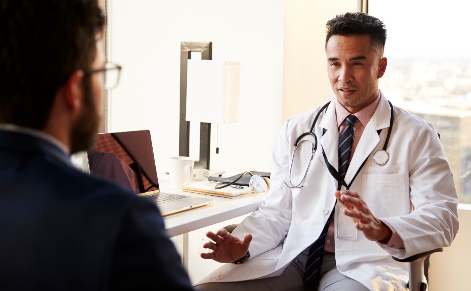 FINALover the shoulder view of man having consultation with male doctor in picture id1132295127