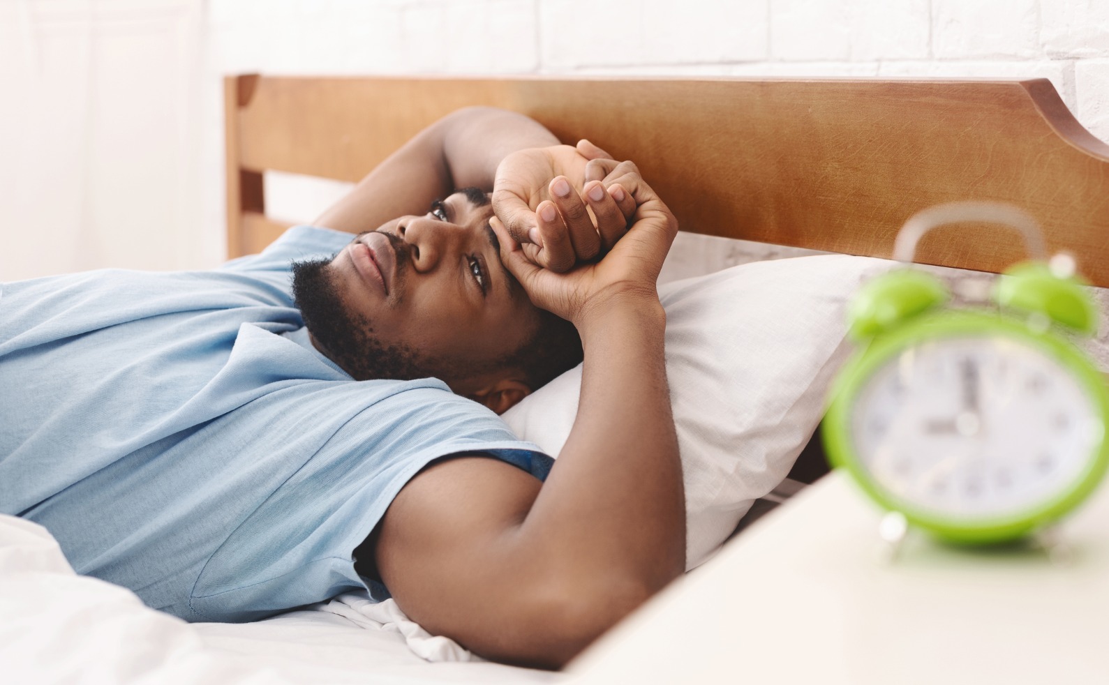 black man in bed suffering from insomnia and sleep disorder picture id1154077697