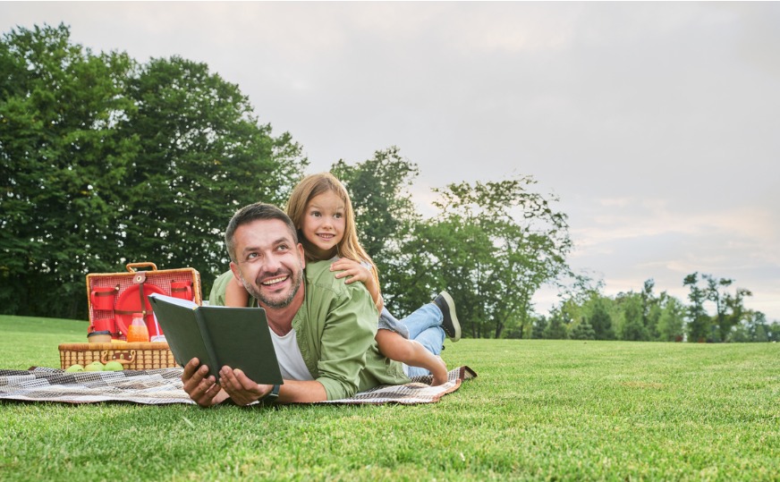 cheerful cute little girl spending time with her father reading a book while having picnic in.jpg s=1024x1024&w=is&k=20&c=ohOftnkUYHlUfDrfcn1Dvu3fNSFE06DcLFNbQAWclcg=